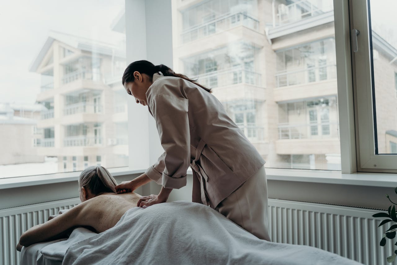 services-04 Woman receiving a back massage in a spa, promoting relaxation and wellness.